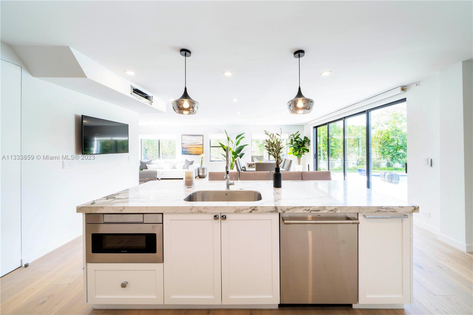 5334 Pine Tree Drive Miami Beach, FL 33140 - Photo 9 of 42 a kitchen with a sink stove and microwave