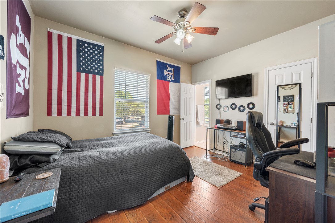 114 Lynn Drive Bryan, TX 77801 - Photo 13 of 31 a bedroom with a bed and a flat screen tv