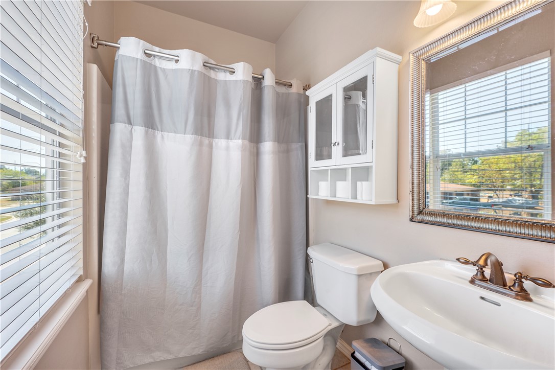 114 Lynn Drive Bryan, TX 77801 - Photo 14 of 31 a bathroom with a sink toilet and shower