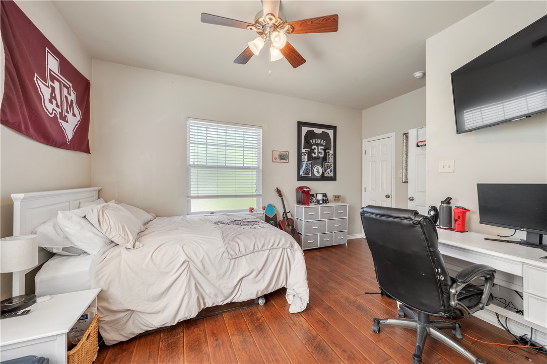 114 Lynn Drive Bryan, TX 77801 - Photo 15 of 31 a bedroom with a bed and a flat screen tv