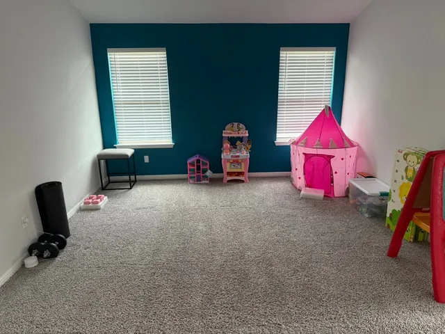 a bedroom with furniture and a window