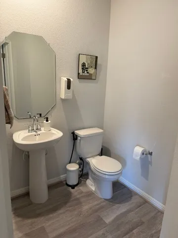 a bathroom with a toilet sink and mirror