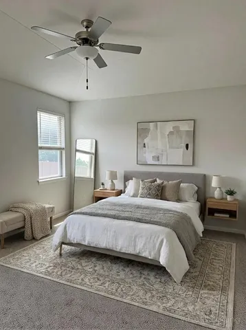 a bedroom with a large bed and a chandelier