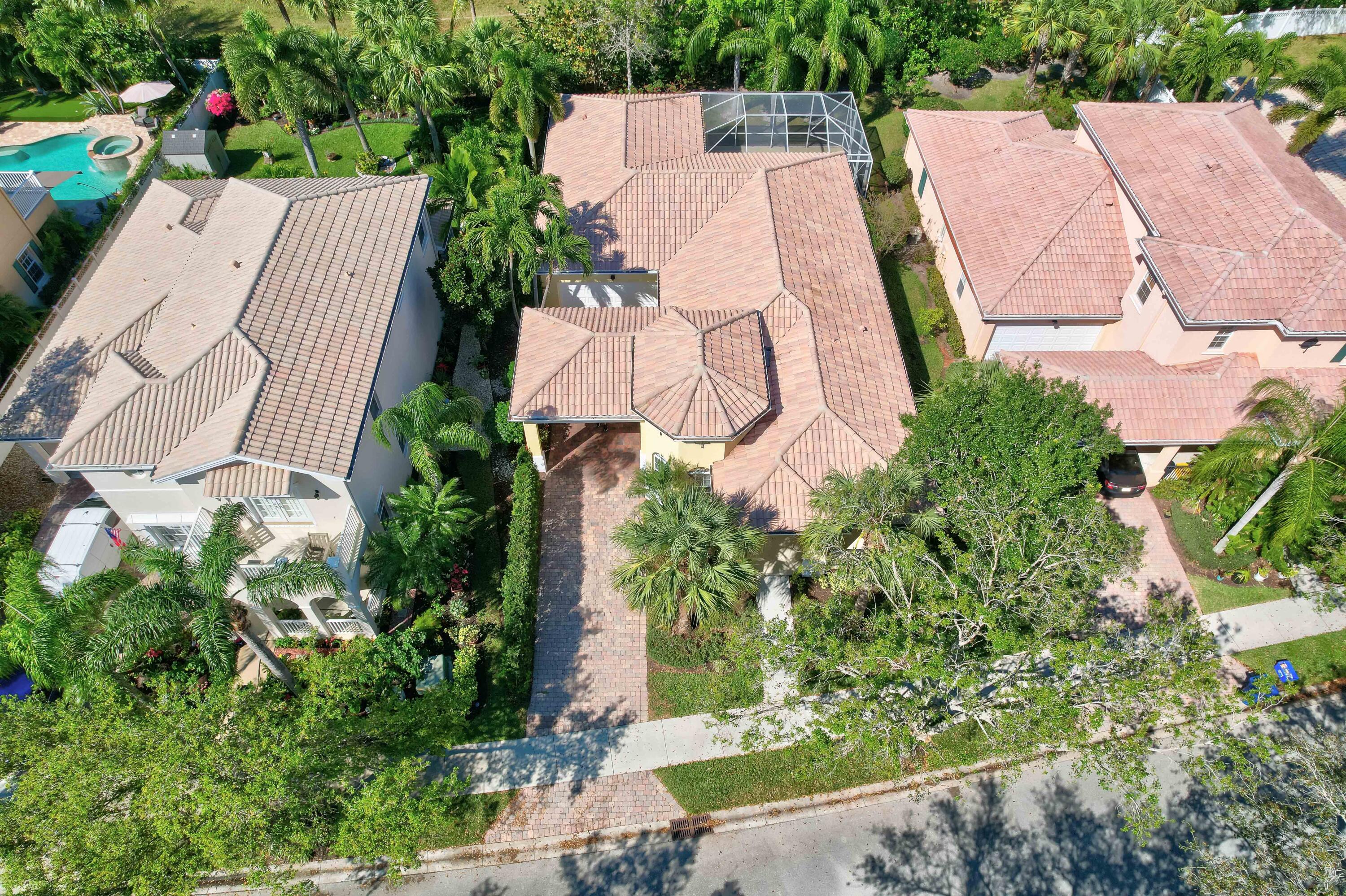 256 San Remo Drive Jupiter, FL 33458 - Photo 13 of 46 an aerial view of a house with a yard and a large tree