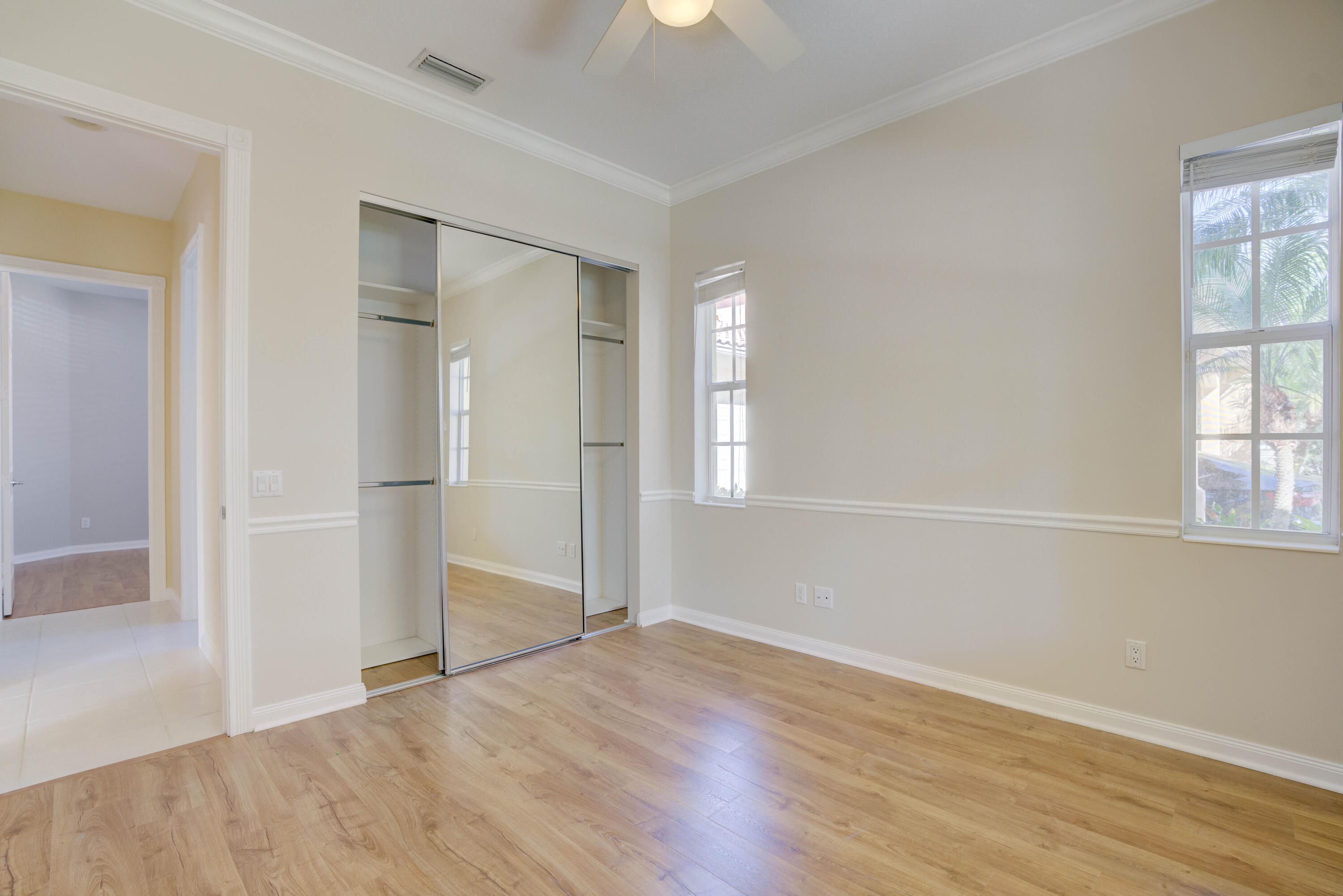 256 San Remo Drive Jupiter, FL 33458 - Photo 22 of 46 wooden floor in an empty room with a window