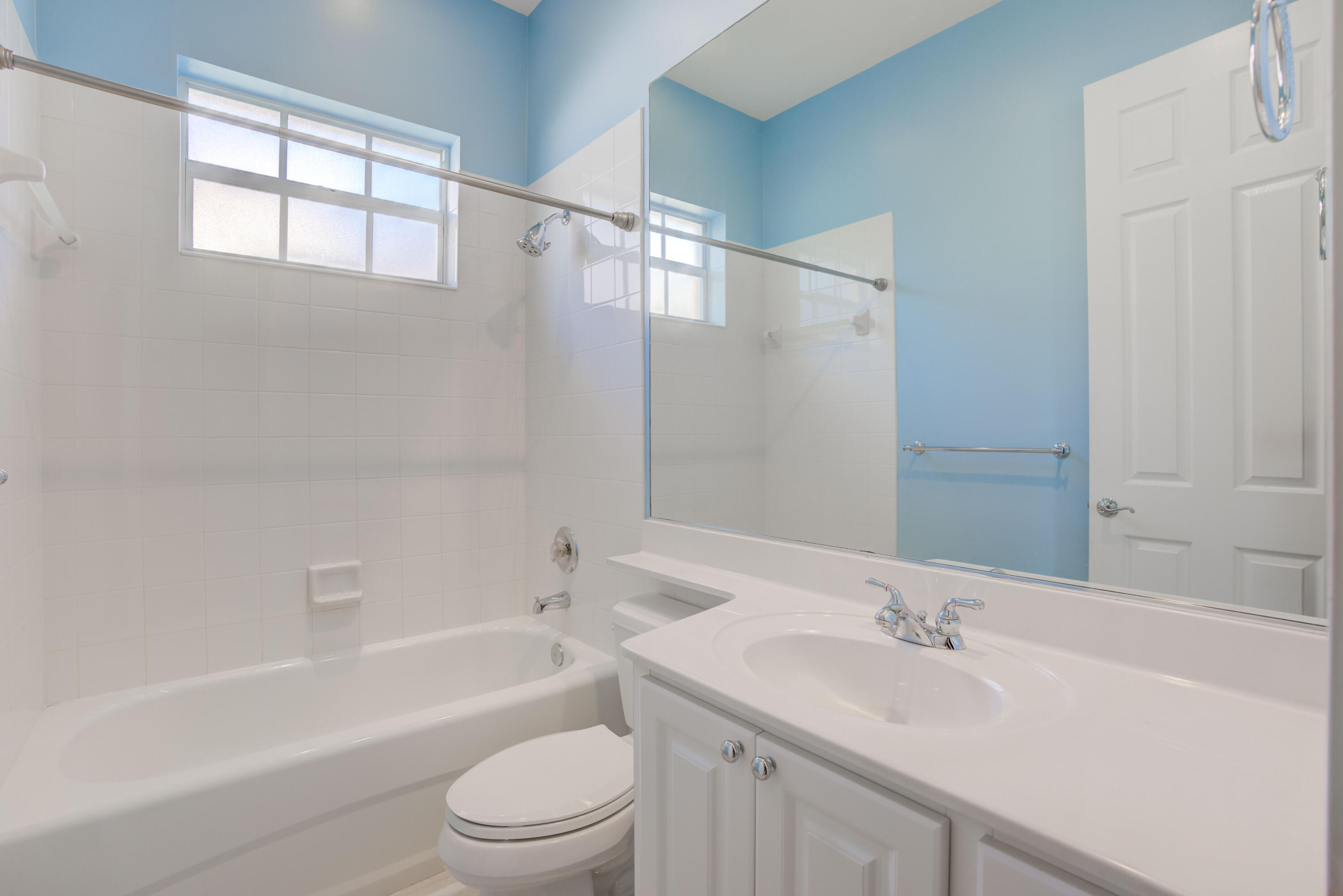 256 San Remo Drive Jupiter, FL 33458 - Photo 23 of 46 a bathroom with a granite countertop sink toilet and bathtub