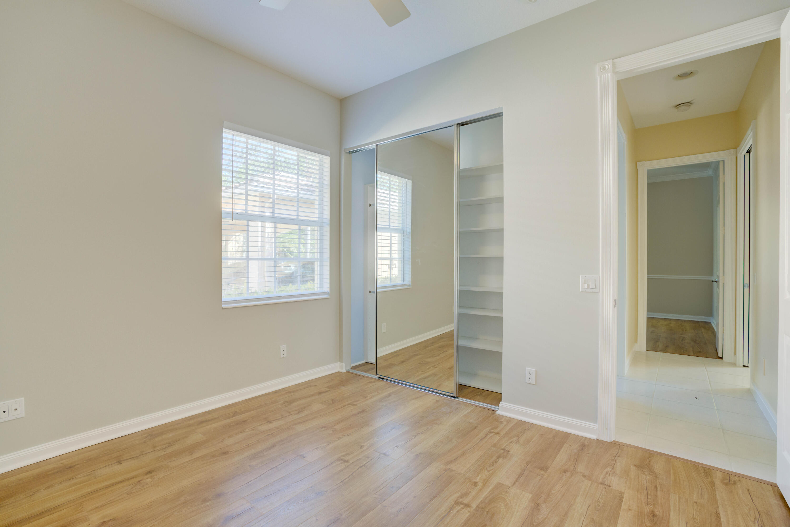 256 San Remo Drive Jupiter, FL 33458 - Photo 25 of 46 an empty room with wooden floor and windows