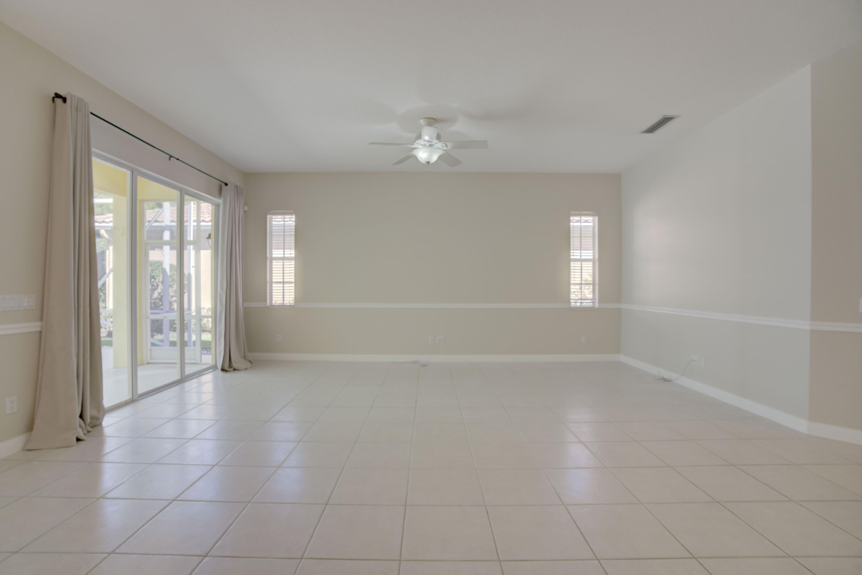 256 San Remo Drive Jupiter, FL 33458 - Photo 29 of 46 wooden floor in an empty room with a window