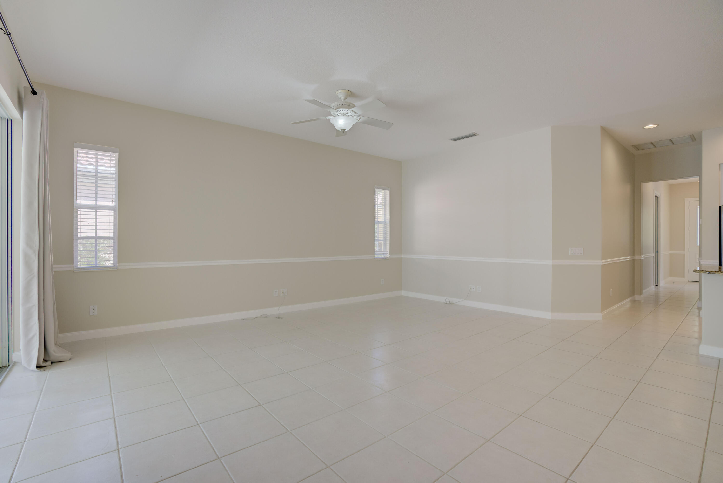 256 San Remo Drive Jupiter, FL 33458 - Photo 30 of 46 wooden floor in an empty room with a window