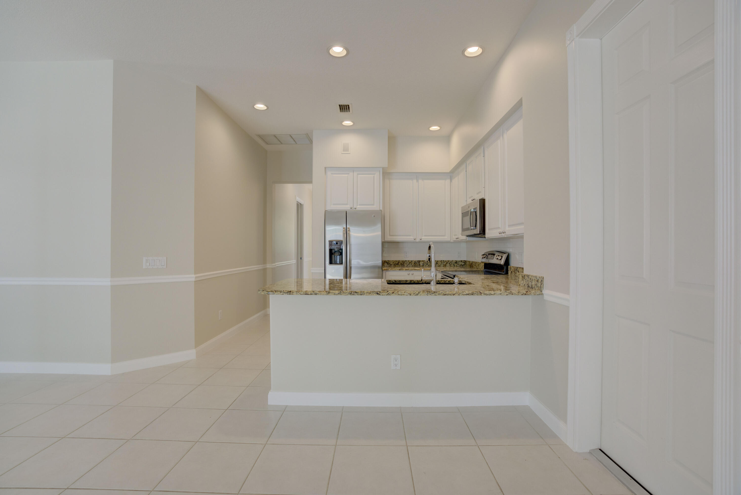 256 San Remo Drive Jupiter, FL 33458 - Photo 35 of 46 a view of kitchen with center island and stainless steel appliances