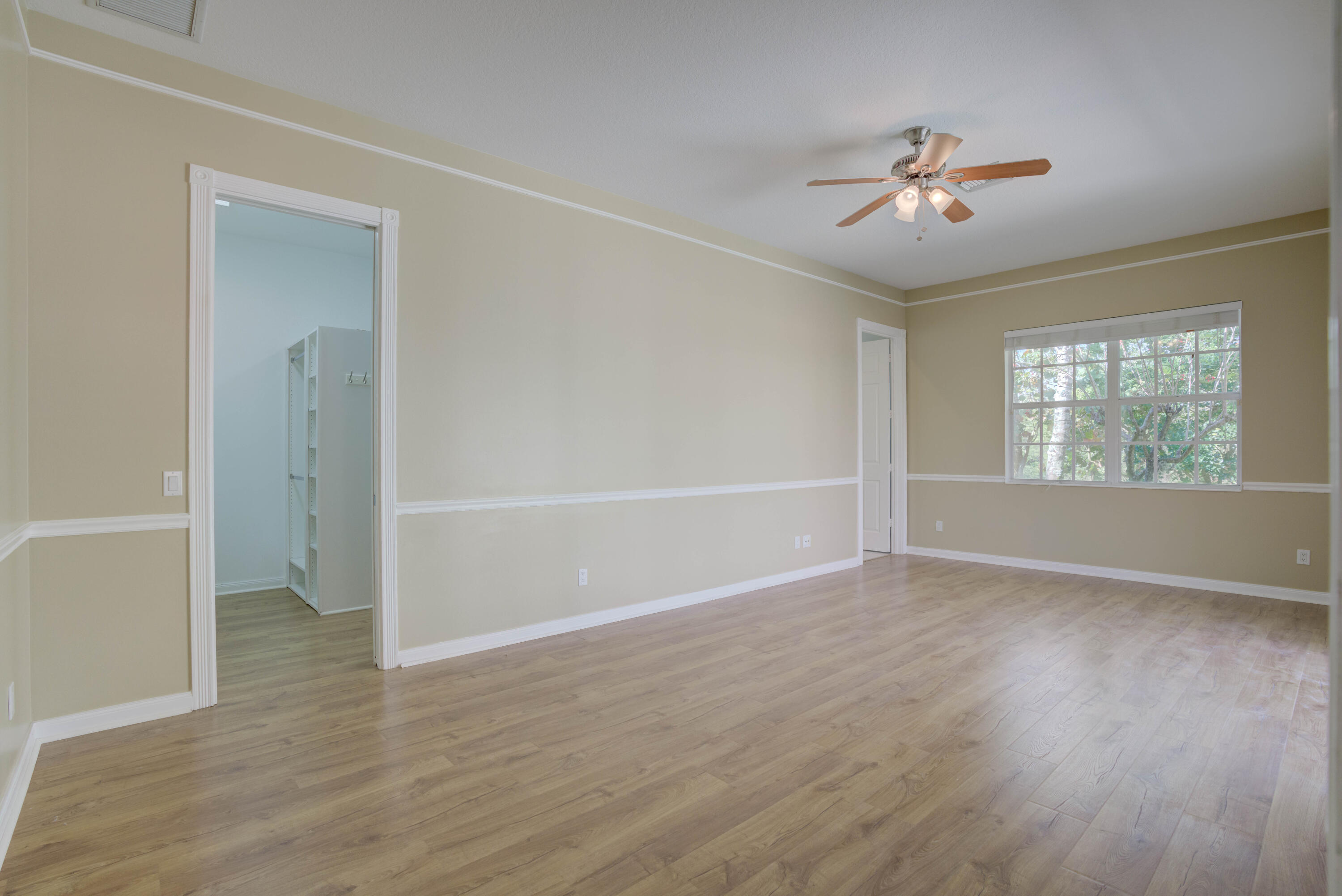 256 San Remo Drive Jupiter, FL 33458 - Photo 37 of 46 a view of an empty room with wooden floor and a window