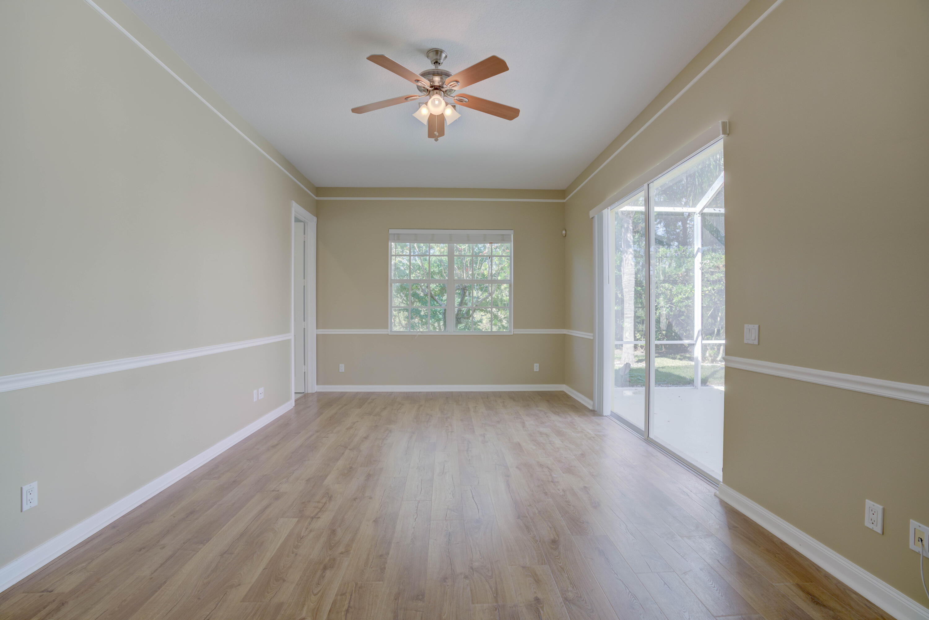 256 San Remo Drive Jupiter, FL 33458 - Photo 38 of 46 wooden floor in an empty room with a window