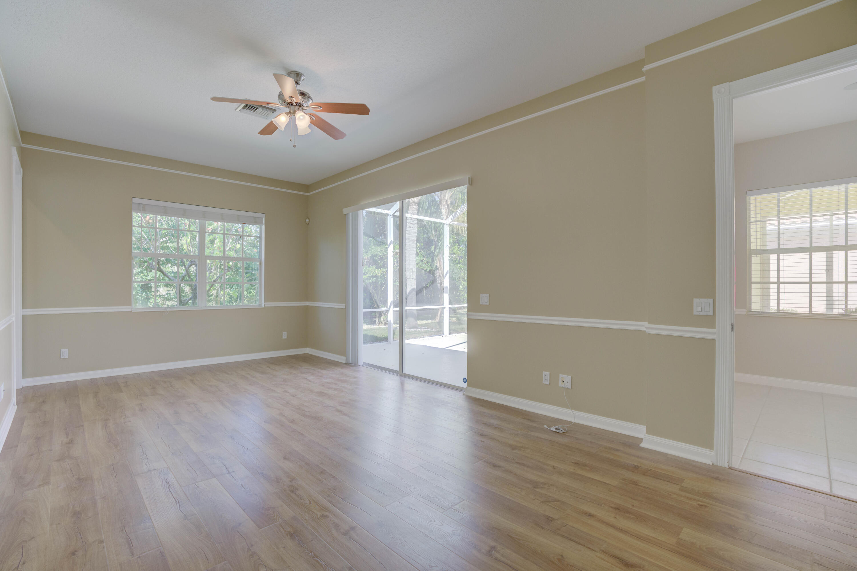256 San Remo Drive Jupiter, FL 33458 - Photo 39 of 46 wooden floor in an empty room with a window