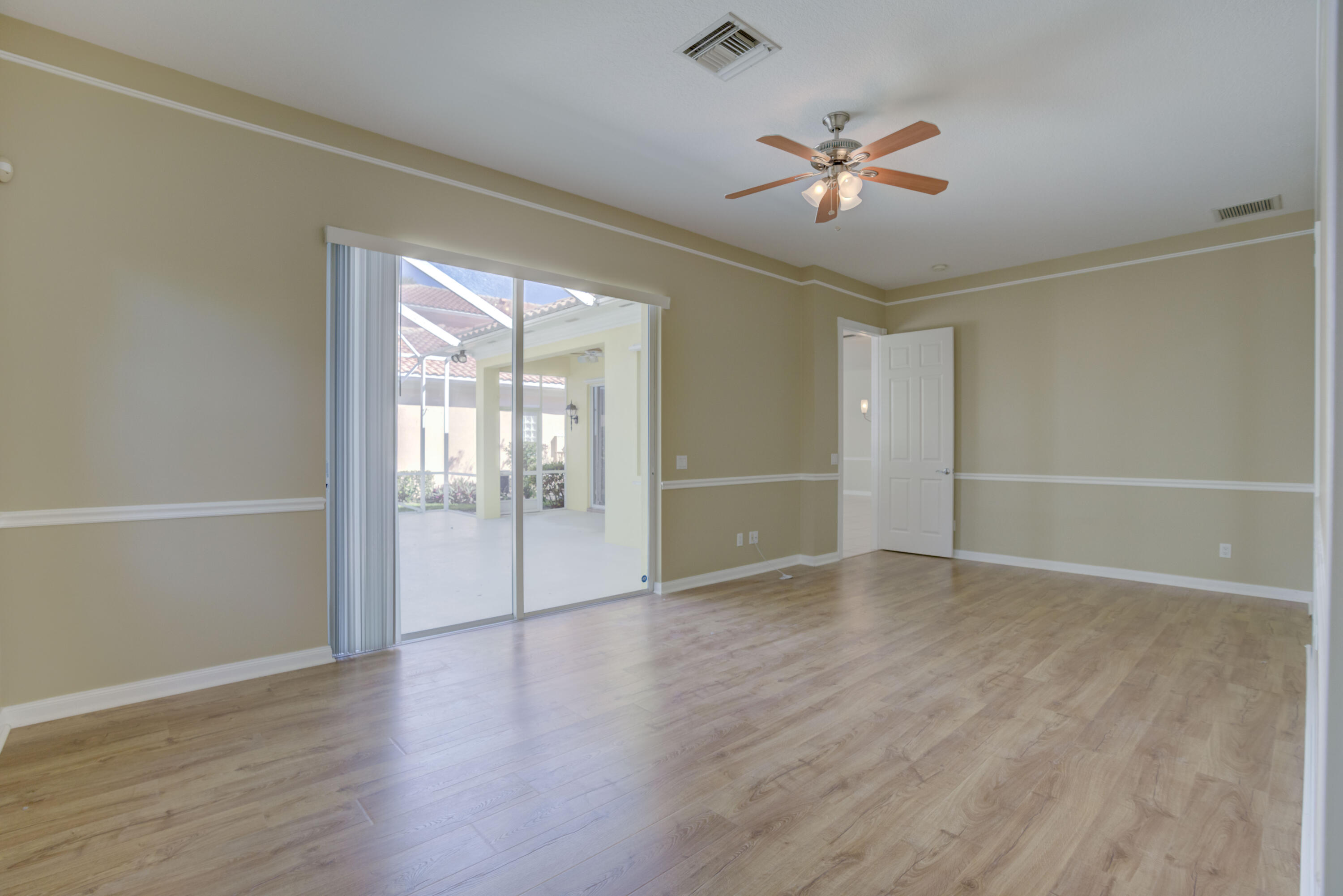 256 San Remo Drive Jupiter, FL 33458 - Photo 40 of 46 an empty room with wooden floor and windows