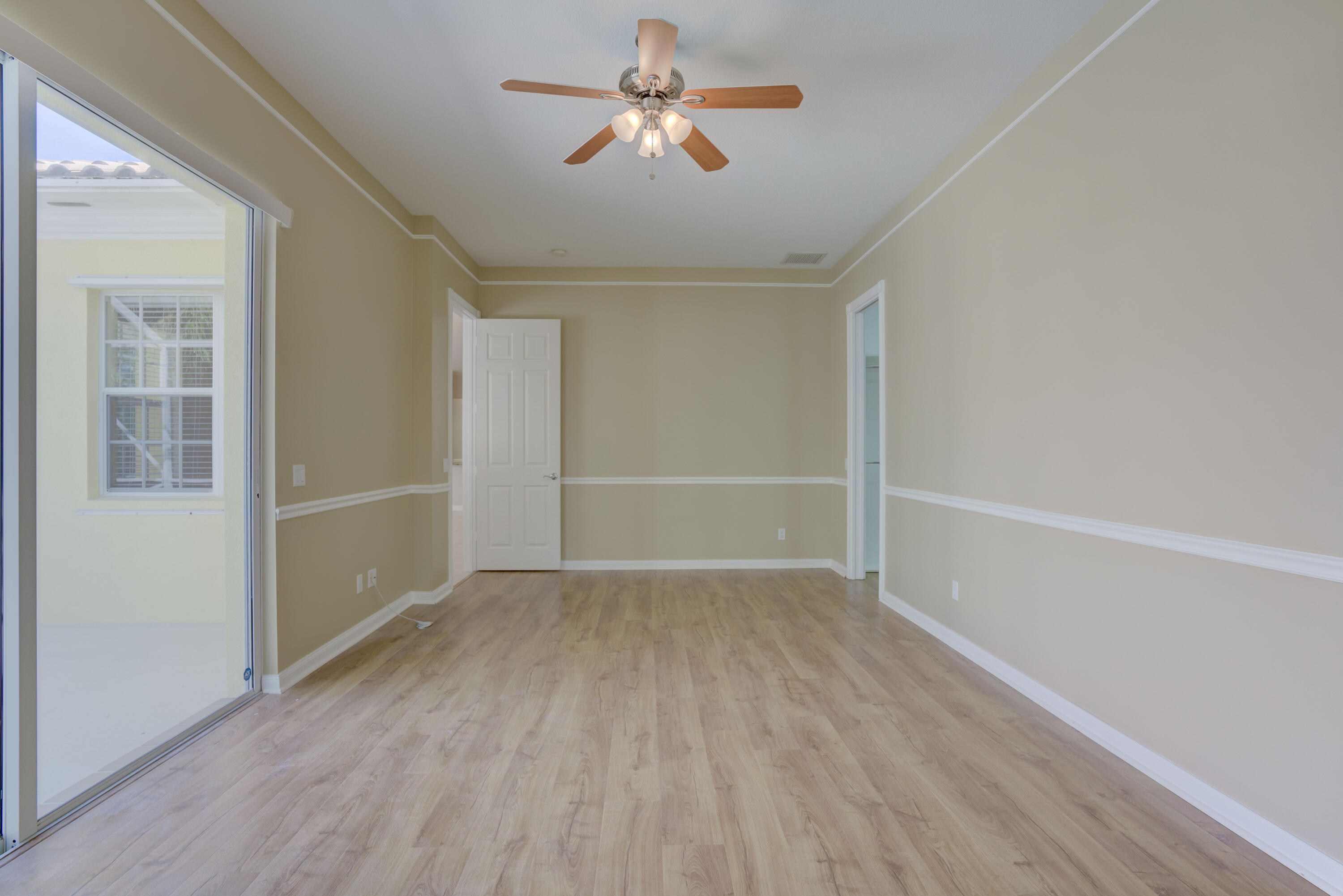 256 San Remo Drive Jupiter, FL 33458 - Photo 42 of 46 wooden floor in an empty room with a window
