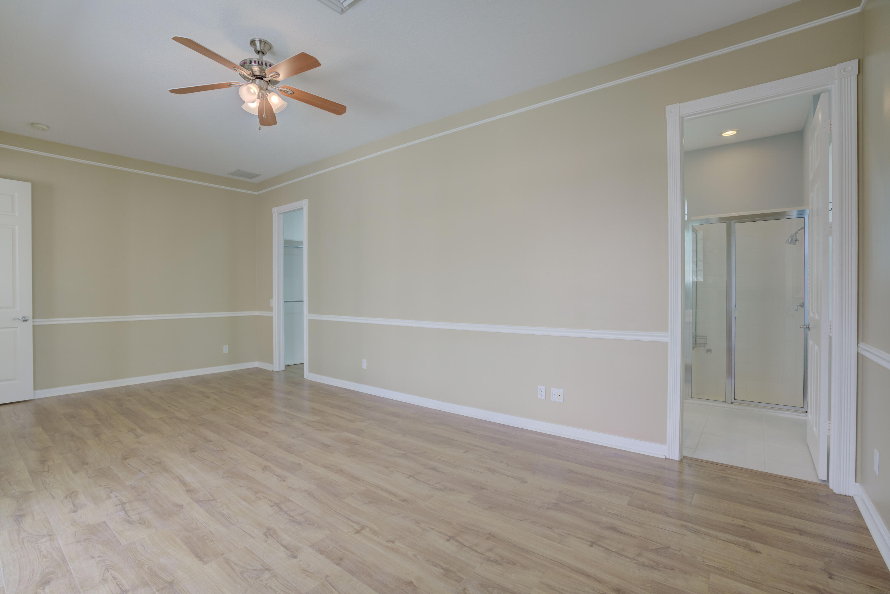 256 San Remo Drive Jupiter, FL 33458 - Photo 43 of 46 an empty room with closet and a chandelier fan