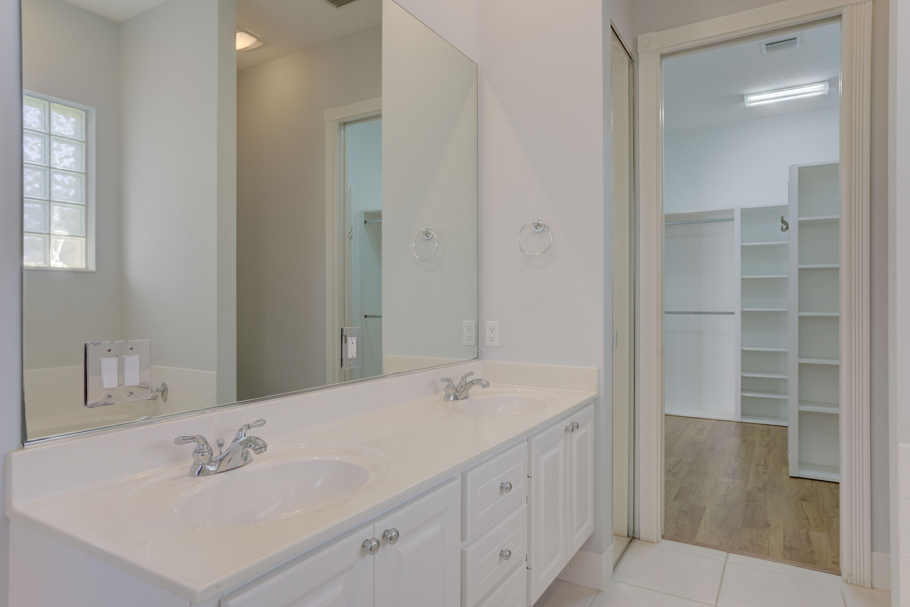 256 San Remo Drive Jupiter, FL 33458 - Photo 45 of 46 a bathroom with a sink and a mirror