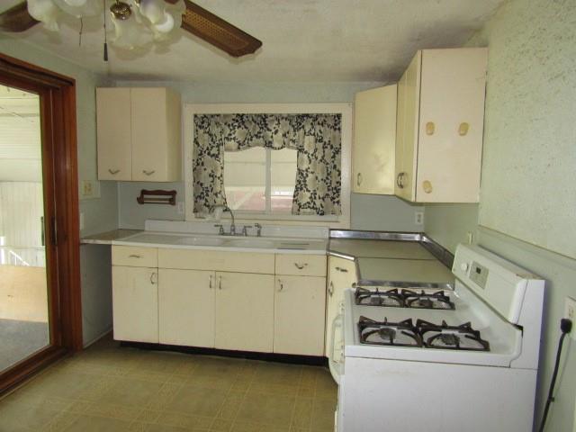 48 Locust Street Ellsworth, PA 15314 - Photo 14 of 26 a kitchen with granite countertop white cabinets and white appliances
