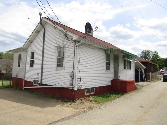 48 Locust Street Ellsworth, PA 15314 - Photo 2 of 26 a front view of a house with a yard