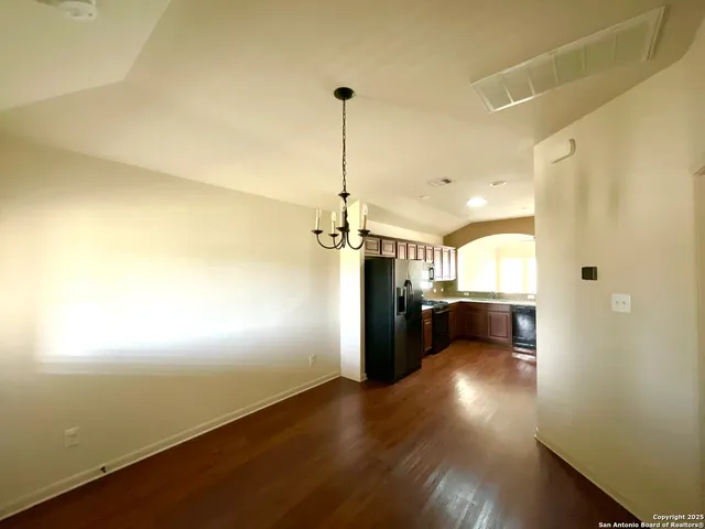 a view of a room with wooden floor and a window