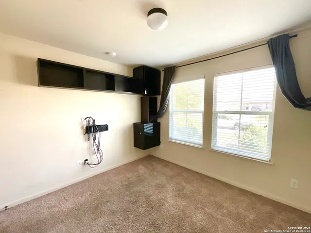 a view of a livingroom with wooden cabinets and outdoor space