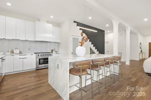 a kitchen with a table chairs stove and cabinets