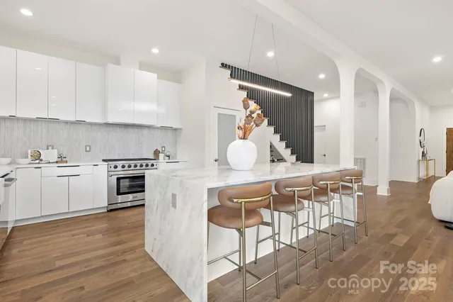 a kitchen with a table chairs stove and cabinets