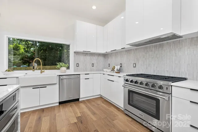 a kitchen with a stove a sink and a refrigerator