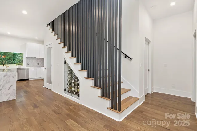 a view of entryway and hall with wooden floor