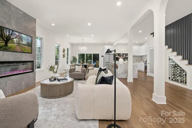 a living room with furniture kitchen view and a fireplace