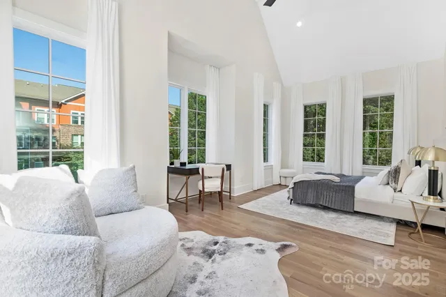 a living room with furniture and large windows