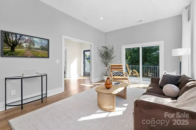a living room with furniture and floor to ceiling window