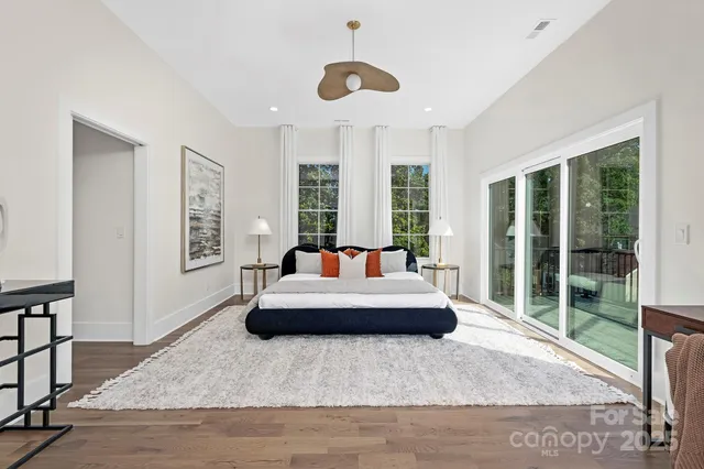 a living room with furniture potted plant and a large window