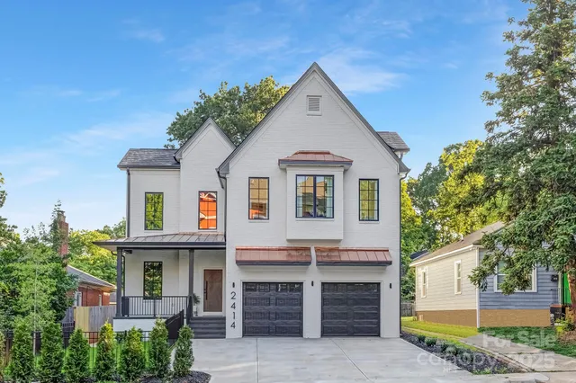 a view of a house with a yard and plants