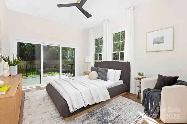 a bedroom with a bed and glass window