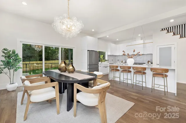 a room with stainless steel appliances kitchen island granite countertop furniture and a large window