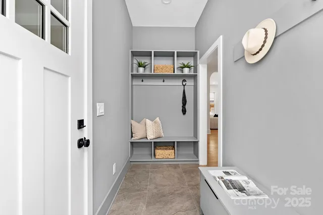 a living room with a bed and cabinets