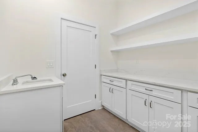 a utility room with cabinets washer and dryer