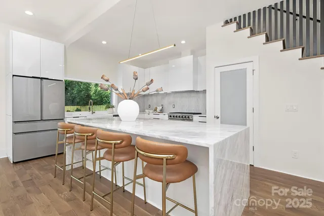 a kitchen with stainless steel appliances a sink and a refrigerator