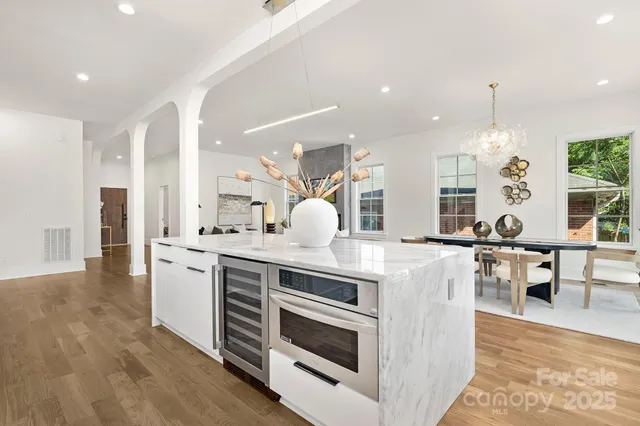 a kitchen with stainless steel appliances granite countertop a stove and cabinets