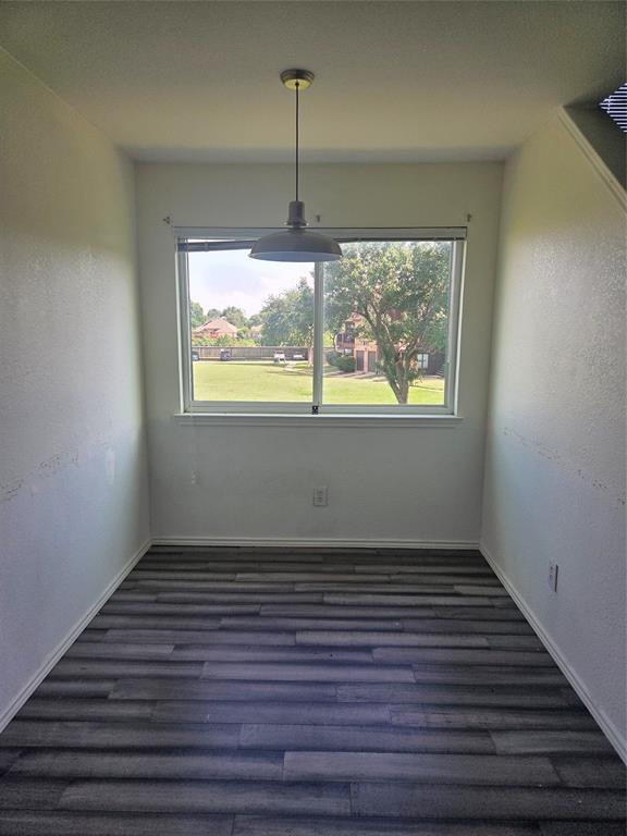 1704 Baird Farm Circle, Unit 4209 Arlington, TX 76006 - Photo 5 of 12 an empty room with wooden floor and windows