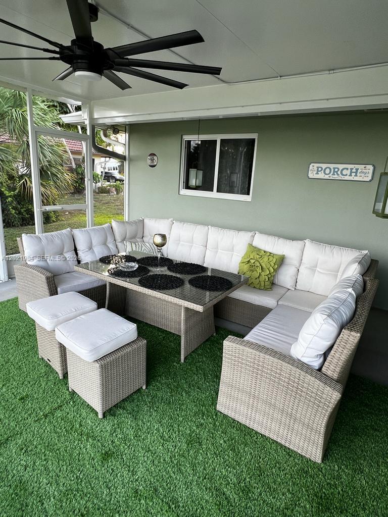 3324 Lakeview Boulevard Delray Beach, FL 33445 - Photo 18 of 36 a view of a patio with couches and a table and chairs