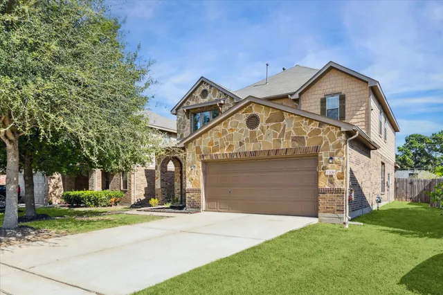 a front view of a house with a yard and garage