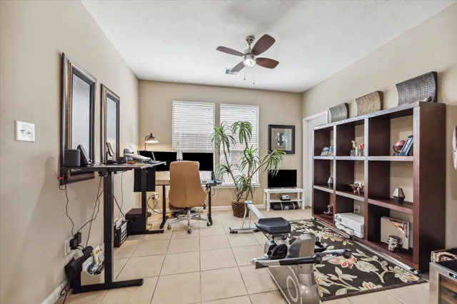 a view of a workspace with furniture and a window