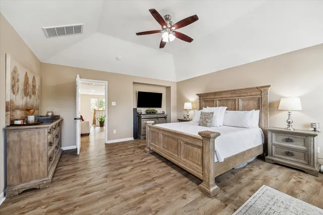 a large white bedroom with a bed and a chandelier