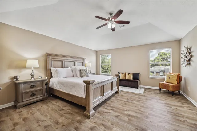 a spacious bedroom with a bed and a couch