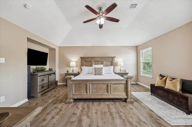 a bedroom with a bed and a flat screen tv