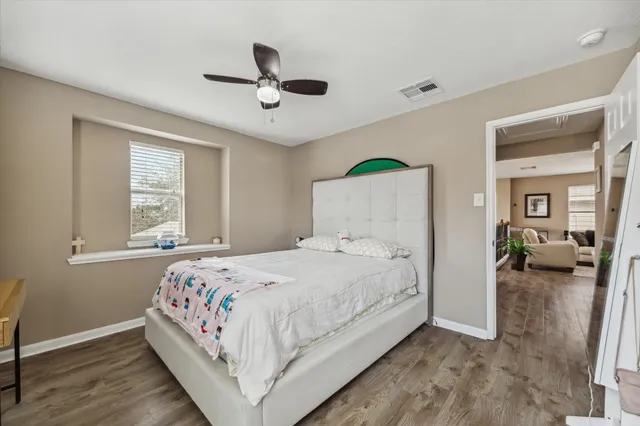 a bedroom with a bed and a window