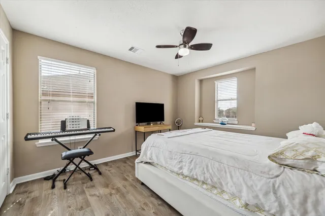 a bedroom with a bed window and a table