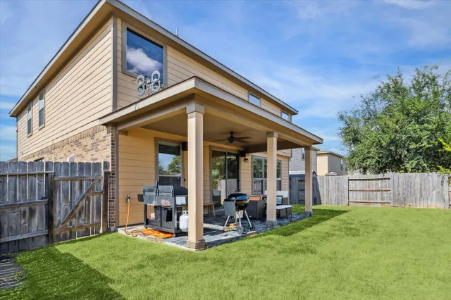 a view of a house with a yard and sitting area